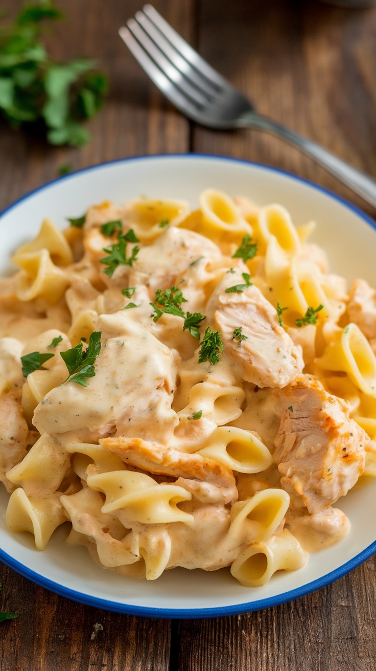 Creamy White Cheddar Chicken Pasta Recipe Creamy white cheddar chicken pasta with parsley garnish on a rustic table.